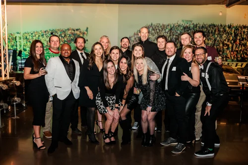 Group photo at a year-end celebration at the Vehicle Vault in Parker