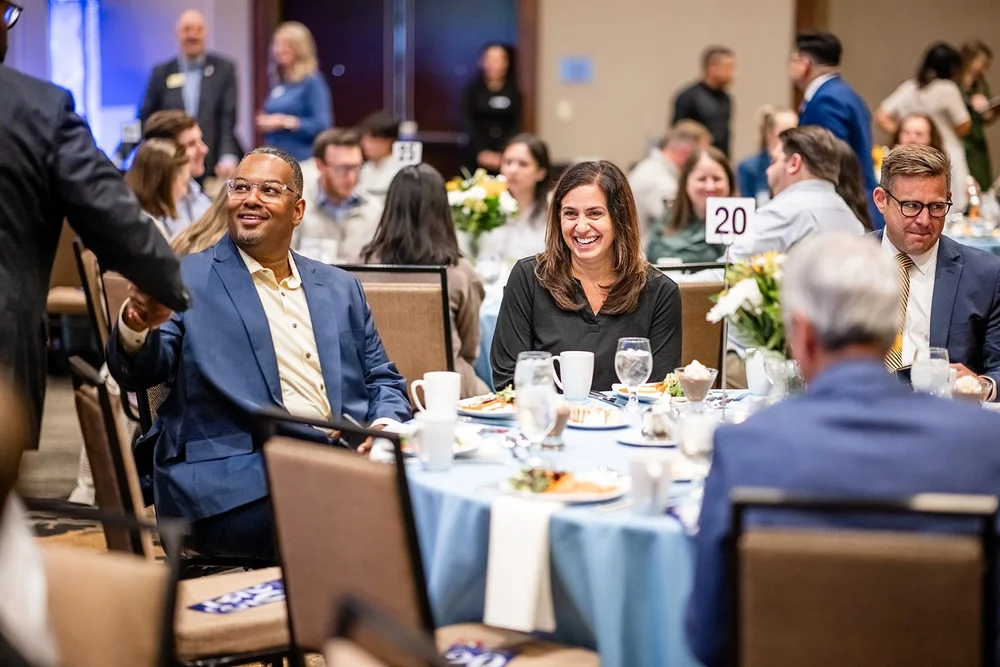 Attendees seated and laughing at tables during CCA Annual Luncheon Hyatt Regency Aurora Denver