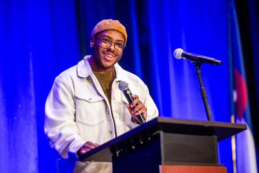 Student spoken word artist at microphone Community College of Aurora Annual Luncheon Hyatt Regency Aurora Colorado