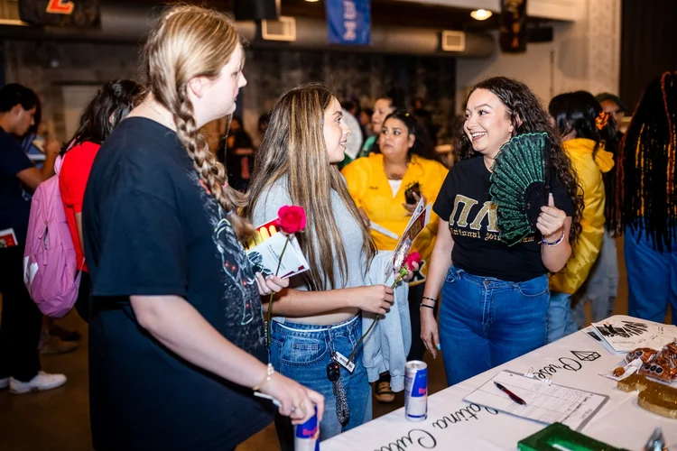 Pi Lambda Theta sorority member recruiting at Meet the Greeks Tivoli Turnhalle MSU Denver