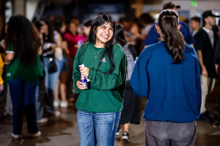 Student smiling at Meet the Greeks Greek life fair Tivoli Turnhalle Auraria Campus Denver