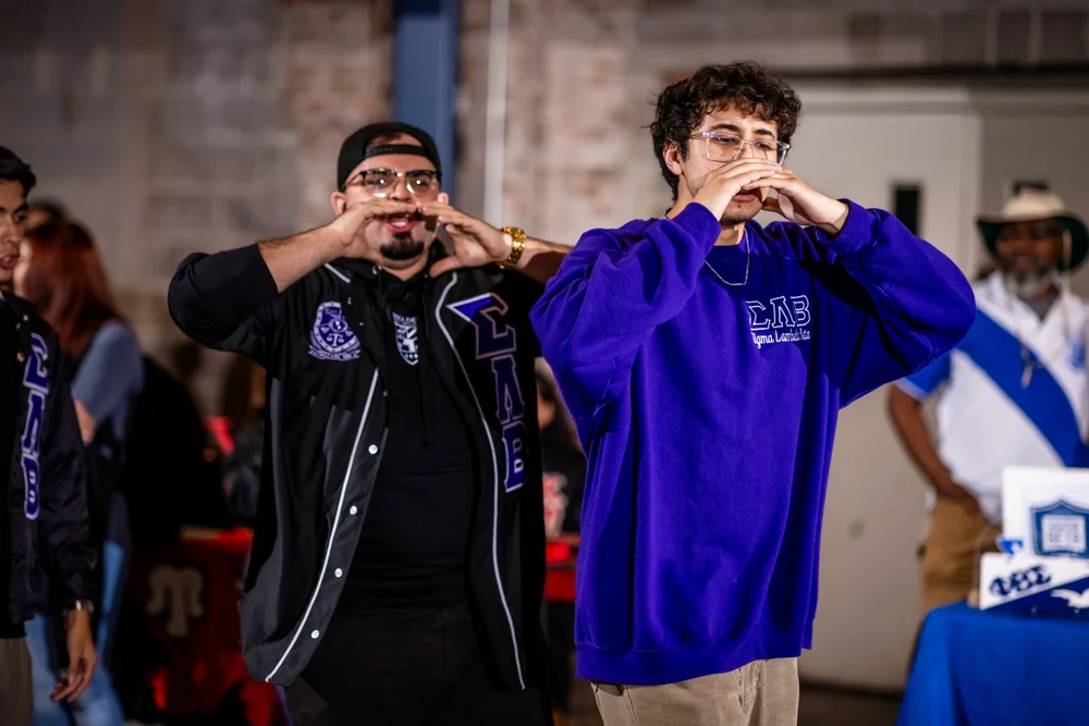 Sigma Lambda Beta fraternity members performing at Meet the Greeks MSU Denver event