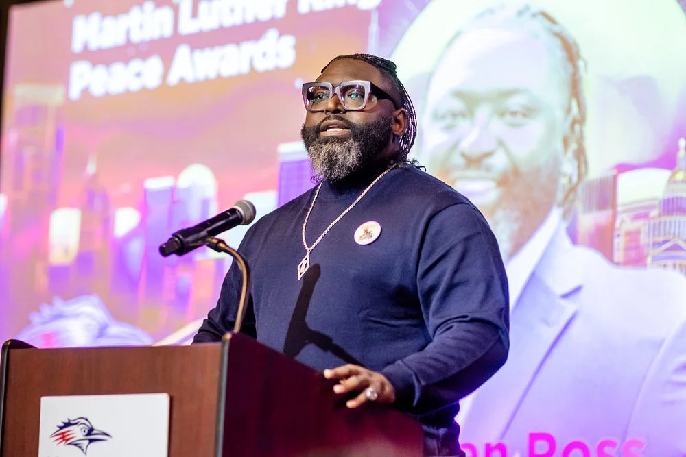 Speaker at podium during Martin Luther King Peace Awards presentation MSU Denver Mile High Station