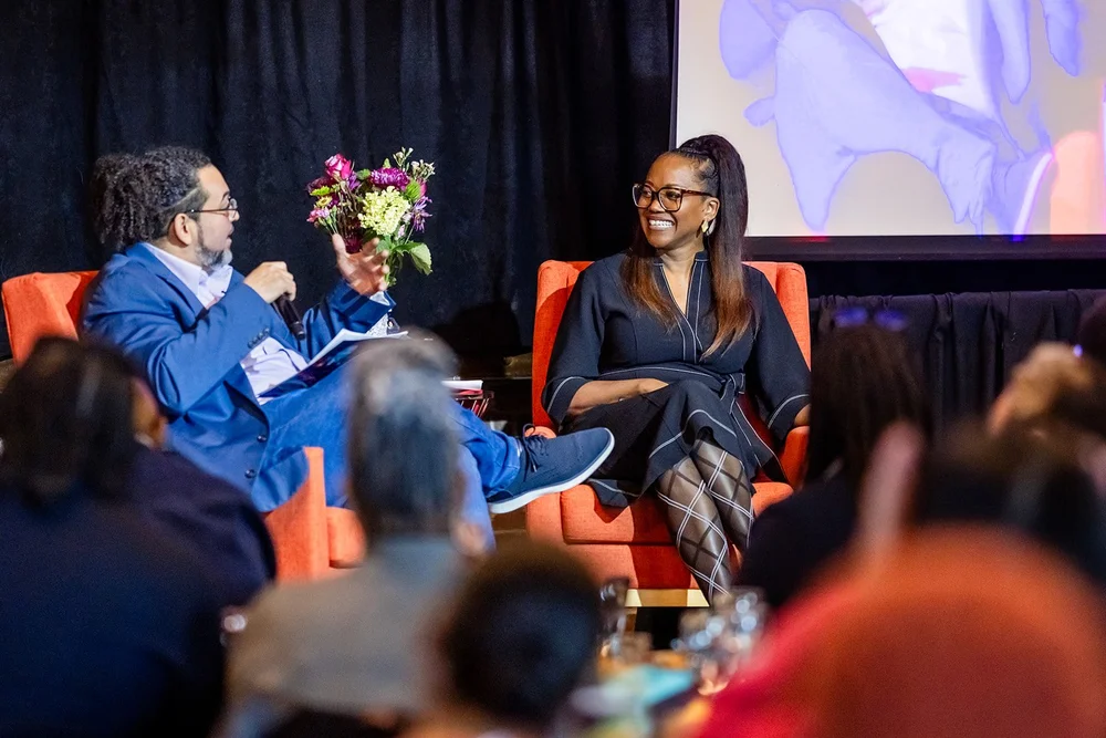 Erika Alexander laughing during seated keynote conversation MLK Peace Breakfast Mile High Station Denver Colorado