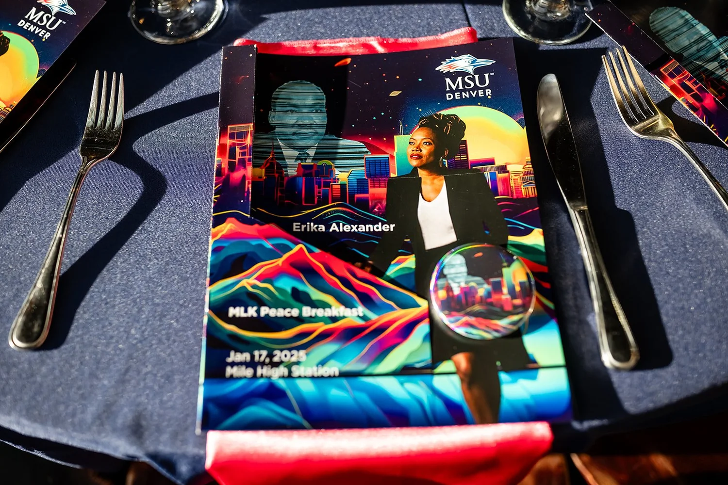 MSU Denver MLK Peace Breakfast program card and commemorative button table detail Mile High Station Denver