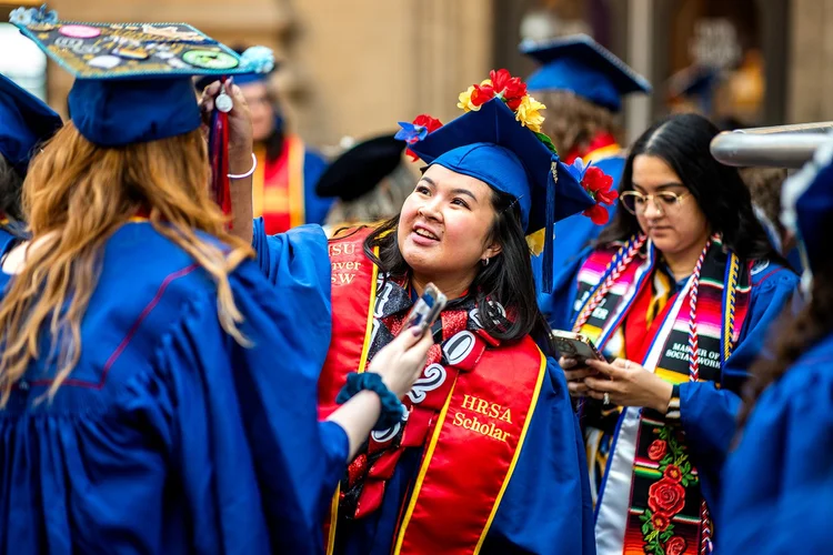 Graduates in regalia at the MSU Denver MSW Pinning and Hooding Ceremony