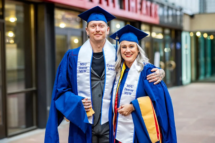 MSU Denver MSW Child Welfare Scholar graduate reflected in glass outside DPAC Denver