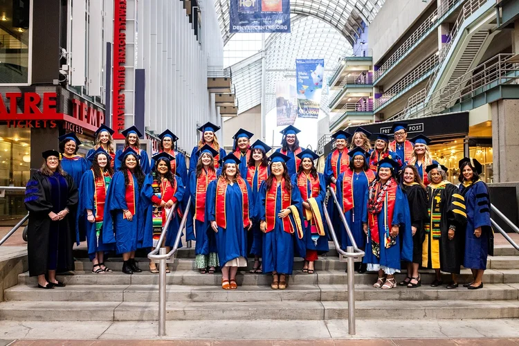 Group of MSU Denver MSW graduates walking and laughing on Curtis Street Denver Colorado