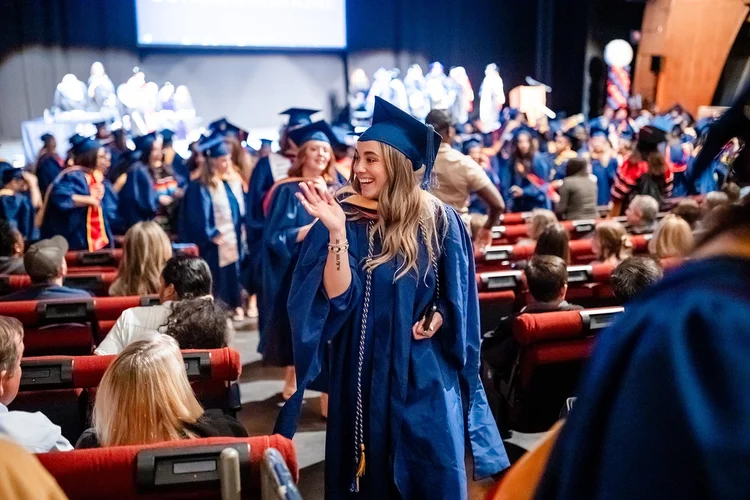 MSU Denver MSW graduate being hooded with HRSA Scholar stole on stage Ellie Caulkins Denver Colorado