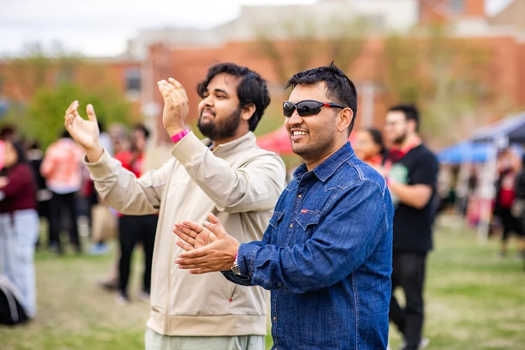 Two students clapping near stage at Roadrunners After Dark MSU Denver Auraria Campus