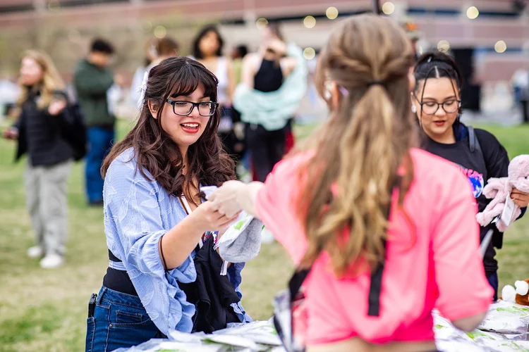 Student smiling at activity booth at Roadrunners After Dark MSU Denver Auraria Campus