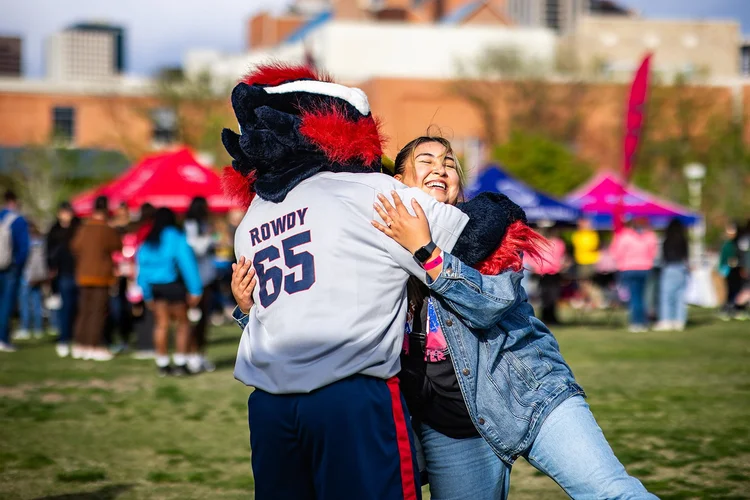 Student hugging Rowdy the MSU Denver mascot at Roadrunners After Dark Auraria Campus