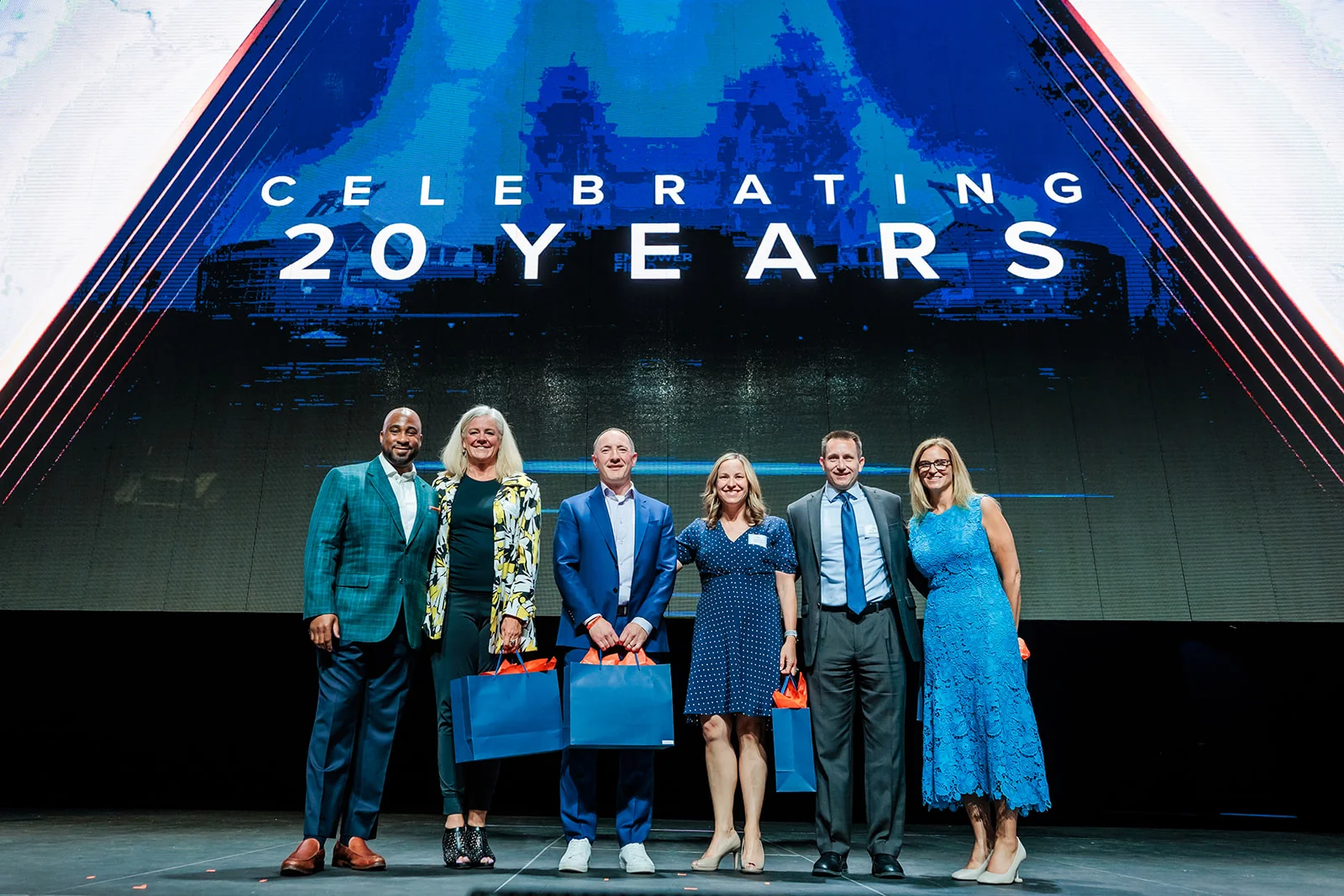 award ceremony group photo on stage at Denver Broncos corporate event Mission Ballroom Denver