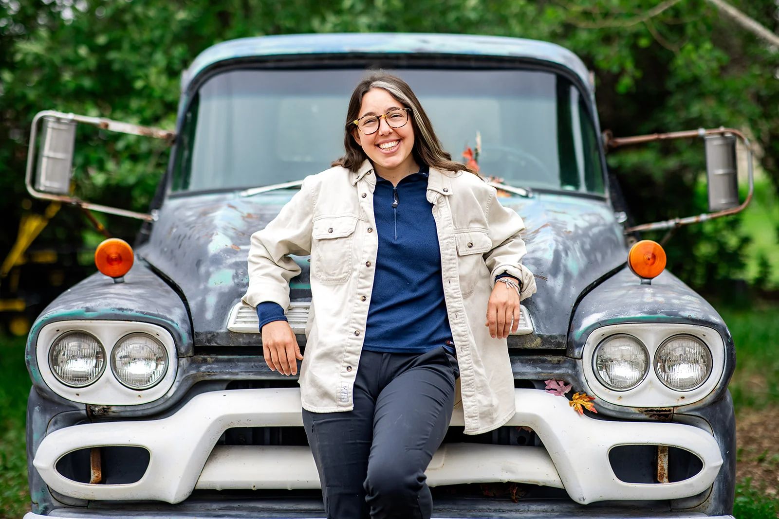 Lifestyle branding portrait of a woman leaning on a vintage truck