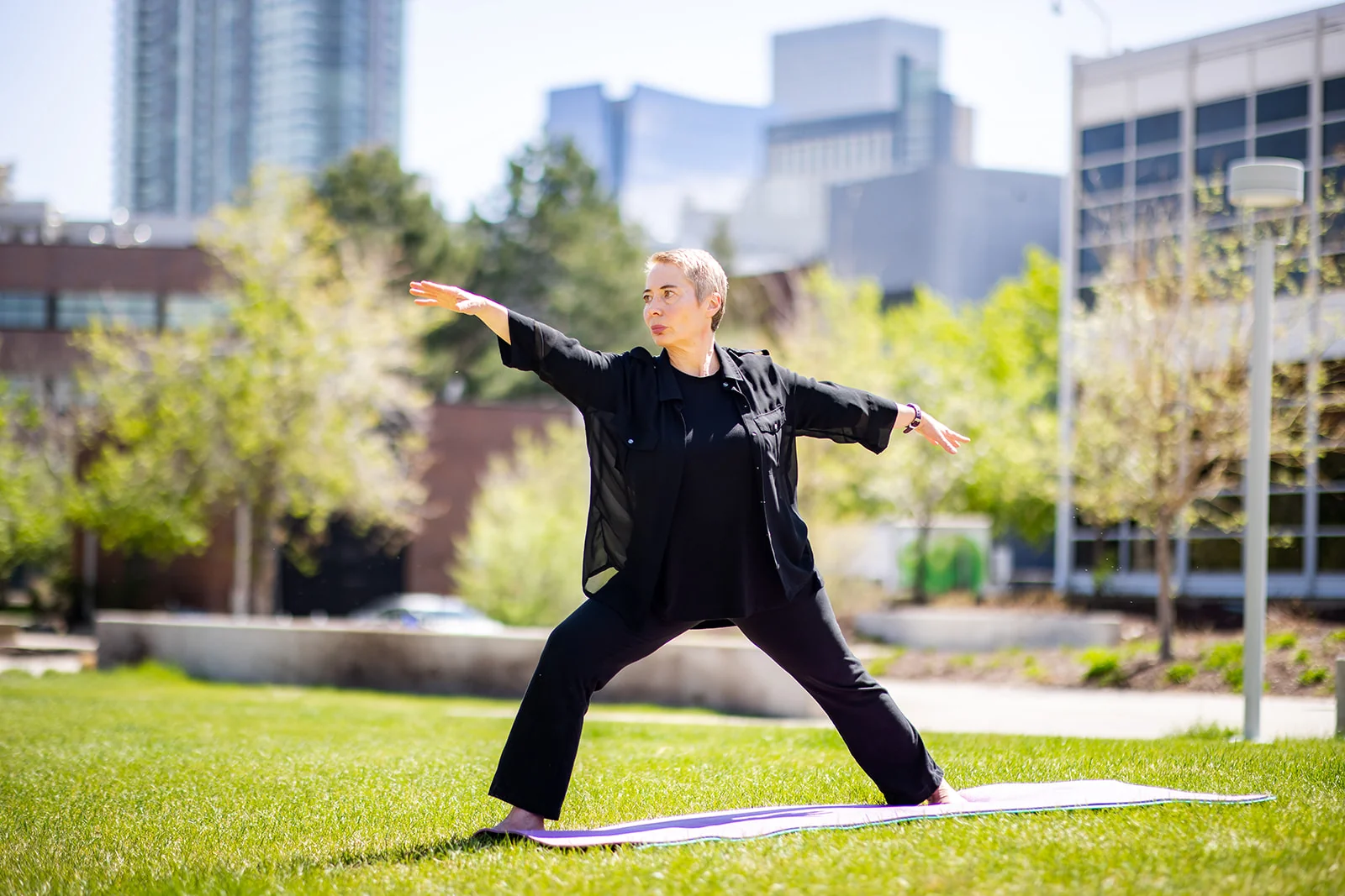 Personal branding photoshoot outdoors in Denver in natural light, subject in a yoga pose on a mat